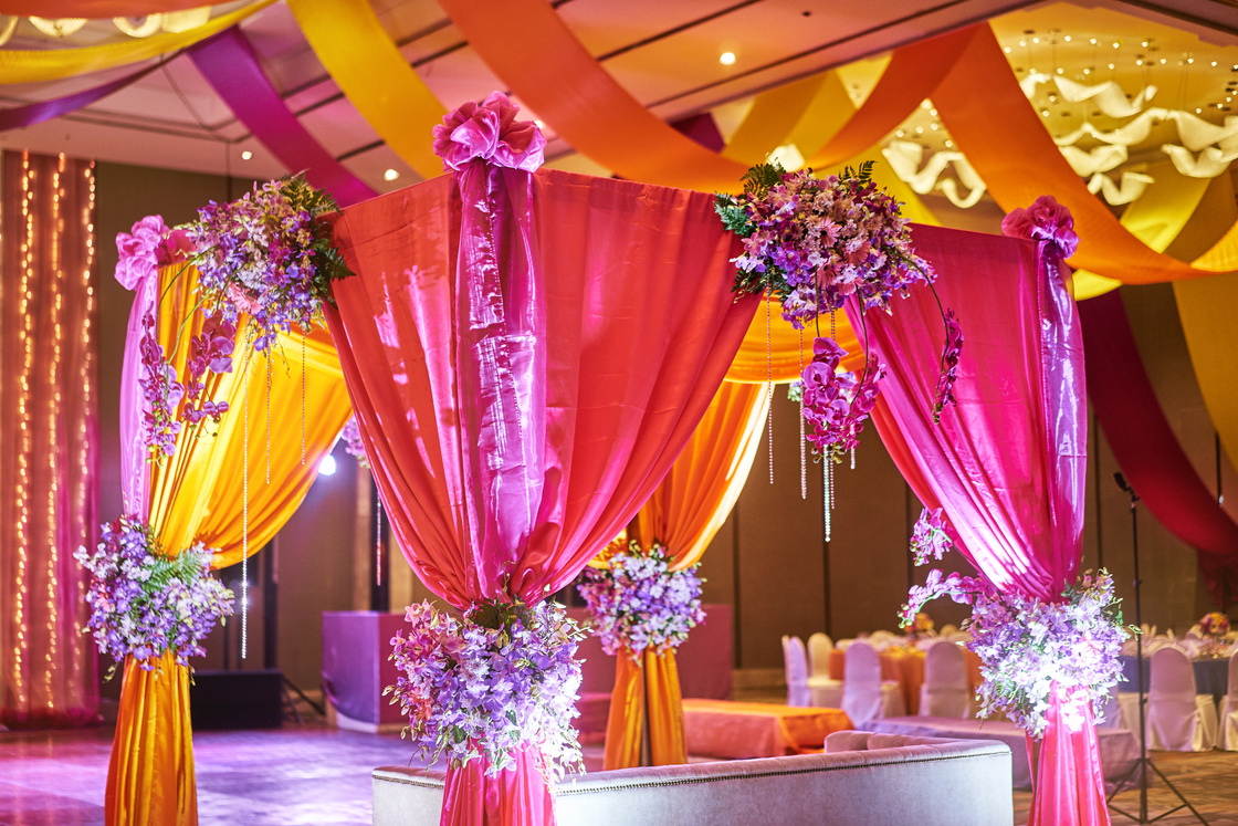 Colorful stage decoration for bride and groom in sangeet night of indian wedding